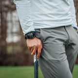 PGA Professional Chris Ryan wearing the GOLFBUDDY aim W11 leaning against his putter